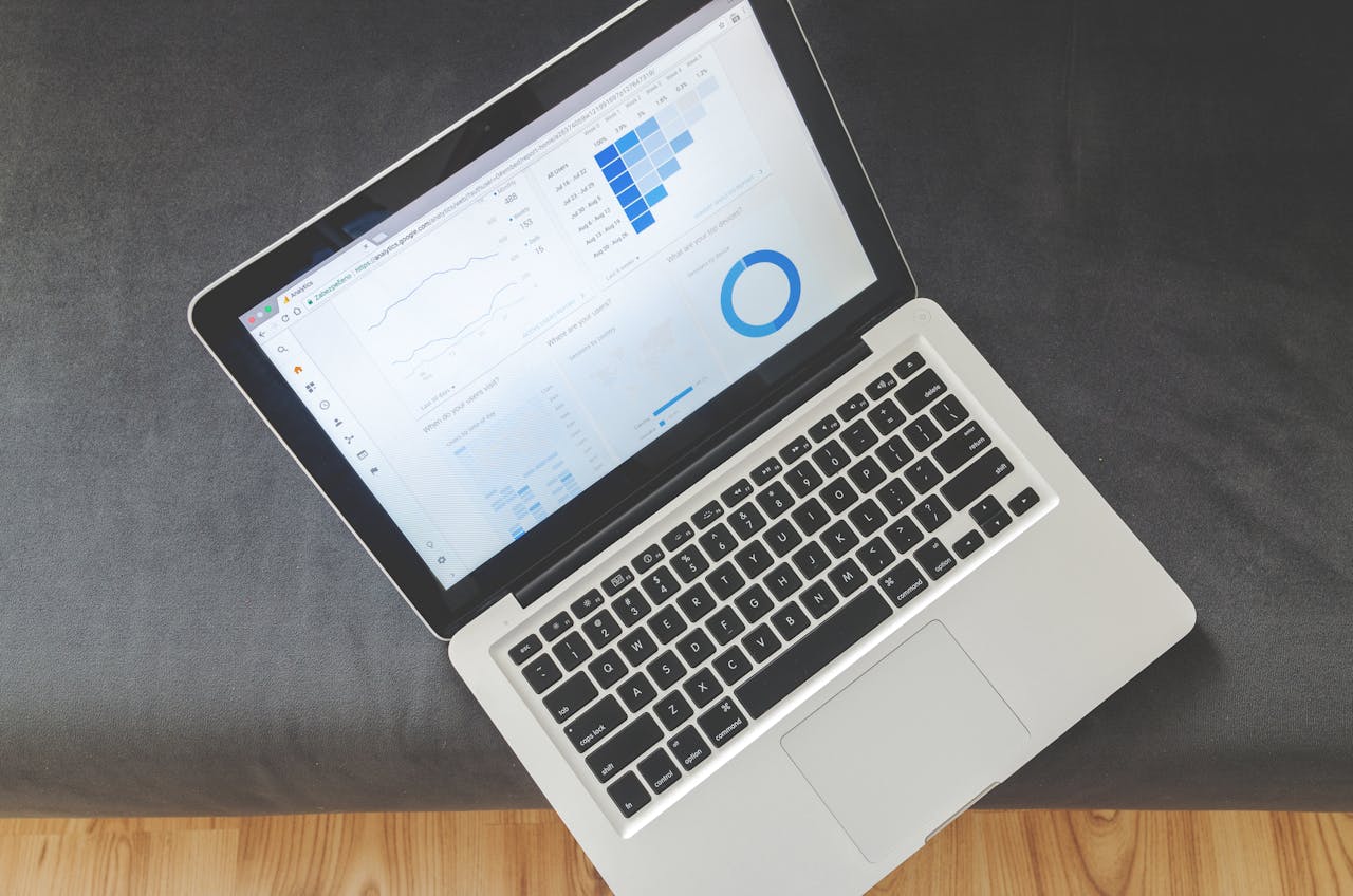 Mastering the First Impression: Your intriguing post title goes here Overhead view of a laptop showing data visualizations and charts on its screen.